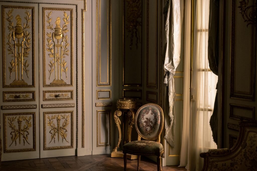 Luxurious interior featuring ornate gold design and classic furniture in a regal setting.